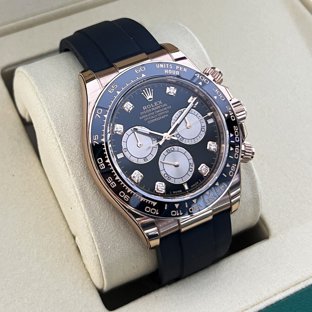 Luxury watch with blue dial and black strap in a display case