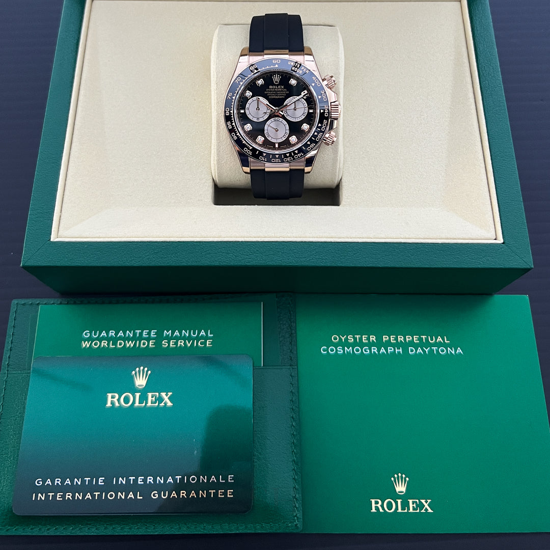 Rolex watch in green box with warranty card on a dark background