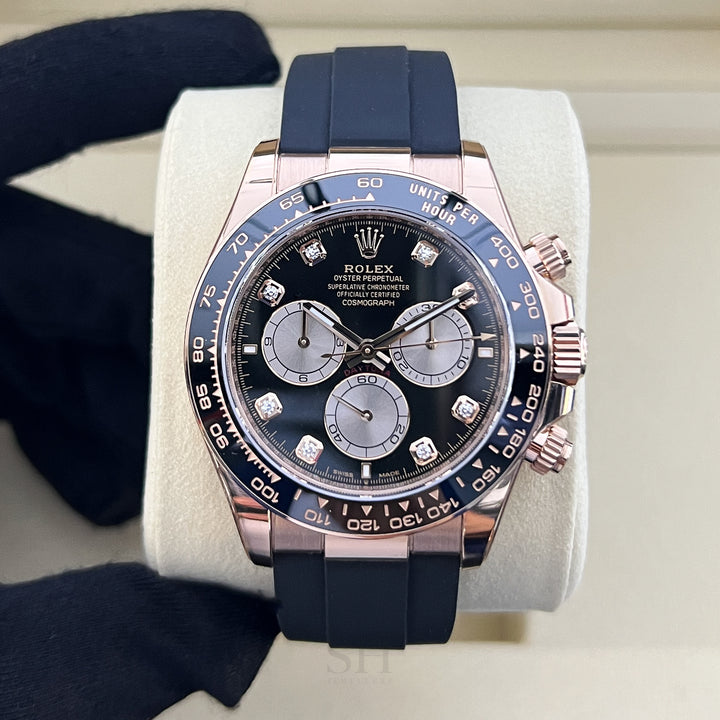 Luxury watch with blue strap and detailed face on a white stand