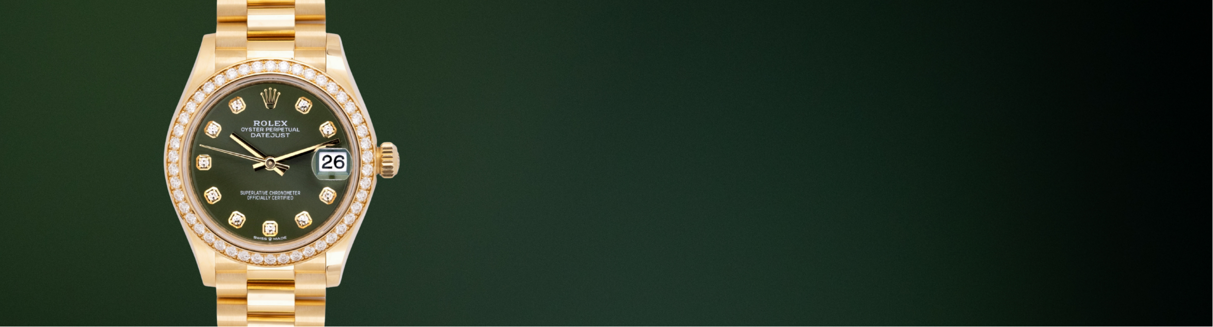 A gold-tone wristwatch with a dark green dial and a bezel set with clear stones, shown against a dark green gradient background.