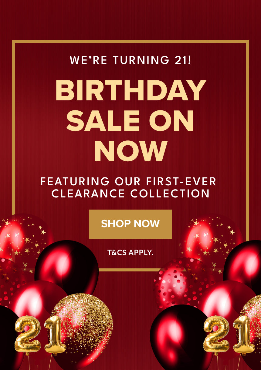 A promotional sale graphic with a dark red background, gold border, large text reading 'BIRTHDAY SALE ON NOW' and 'WE'RE TURNING 21!', plus red and gold balloons and '21' balloons at the bottom. 