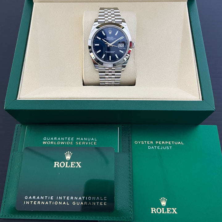 Rolex watch in green box with warranty card