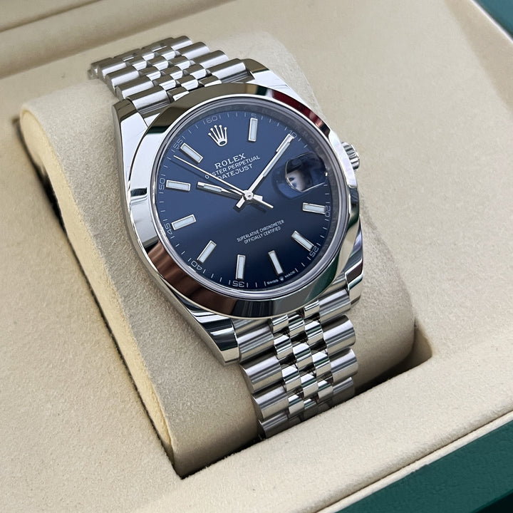 Silver watch with blue dial in a display case