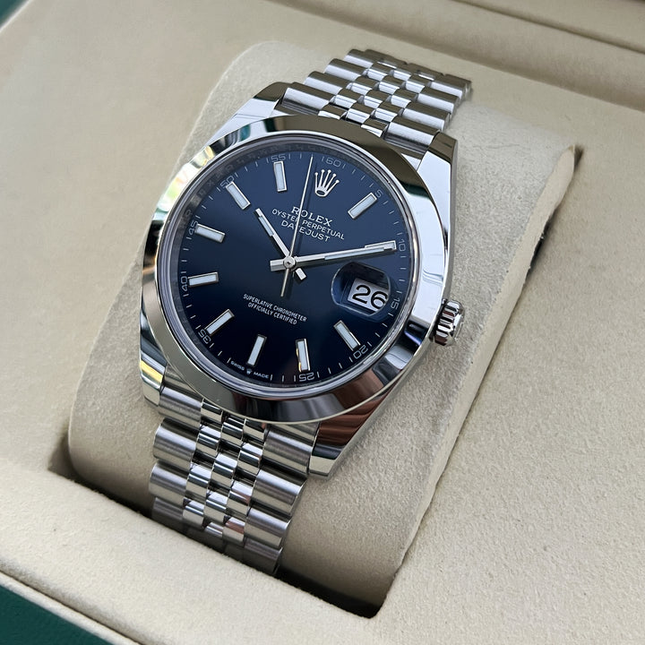 Silver watch with a blue face in a beige display case
